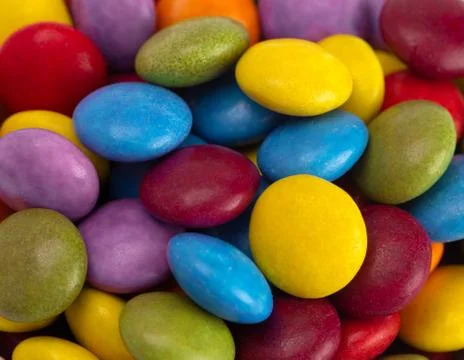 A Background of Candy Coated Multicolored Chocolates Stock Photos