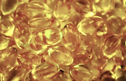Background of capsules cod liver oil, omega 3. Stock Photos