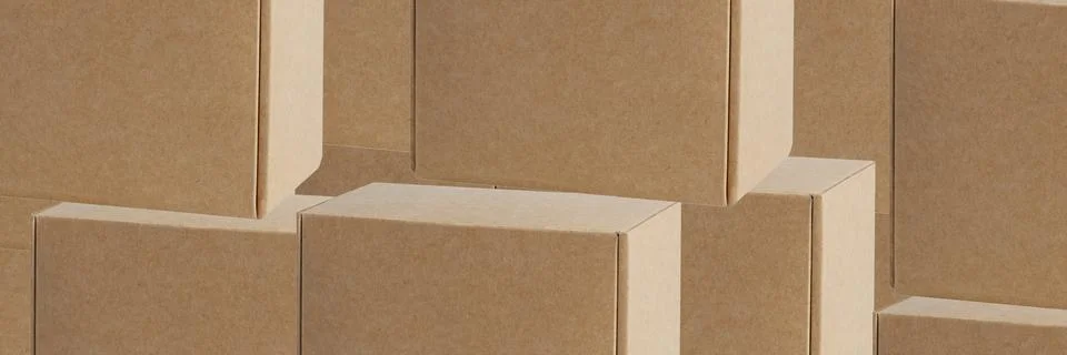 Background of cardboard boxes of various sizes and shapes. Stock Photos