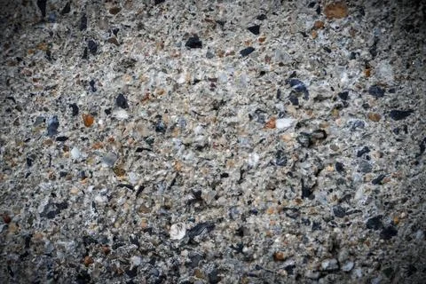Background, Cement wall surface, damaged, revealed that many granite stones. Stock Photos
