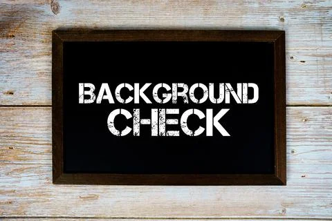 Background Check text written on blackboard flat lay on wooden background Stock Photos
