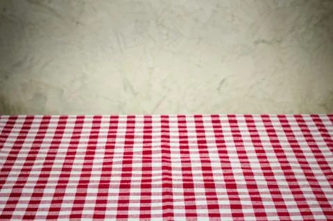 Background with checkered tablecloth and a rustic wall Stock Photos