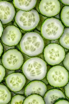 A background of chopped fresh cucumbers for the kitchen.Cucumbers background. Stock Photos