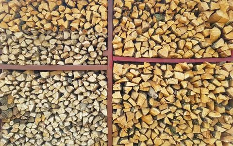 Background of chopped wood lying on top of each other on a wooden shelf Stock Photos