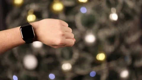 On the background of the Christmas tree on the hand smart watch Video stock 224166600