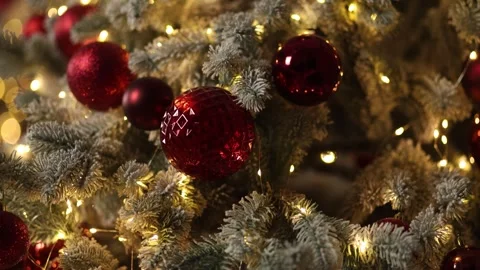 The background is a Christmas tree with white needles, red balls Stock Footage 322945274