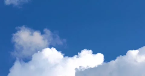 A background of clear blue sky covered with thunderstorm-like white clouds i Stock Footage 338307048