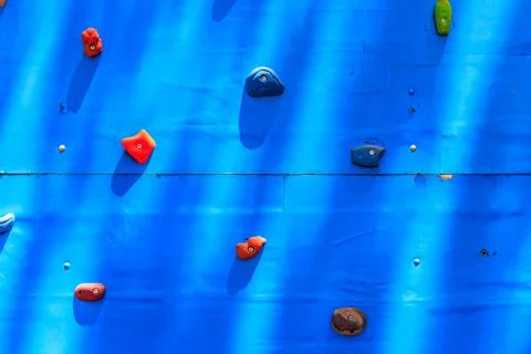 Background of the climbing wall with toe and hand hold studs Stock Photos