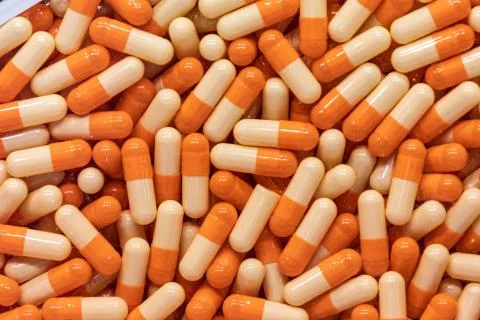 Background - close up of countless colourful orange medicine  pills Stock Photos