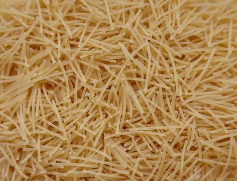 Background closeup pasta texture . small vermicelli. raw small noodles Stock Photos