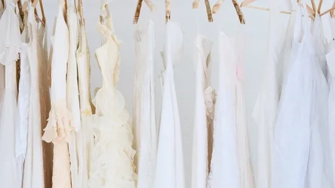 Background of cloth rack full of wedding dresses. Stock Footage 99016574