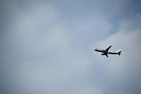 Background of clouds with a plane Stock Photos