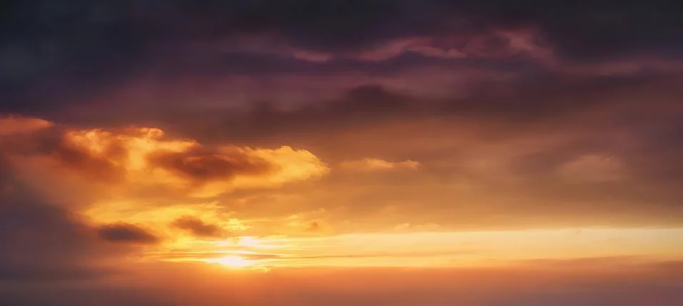 Background of cloudscape at the sunset with sunshine on sky and orange clouds Stock Photos