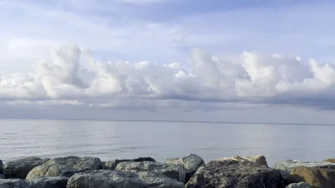 Background Coastal Landscape Featuring Calm Sea and Rocks, Soft Clouds, Tranquil Stock Footage 291783654