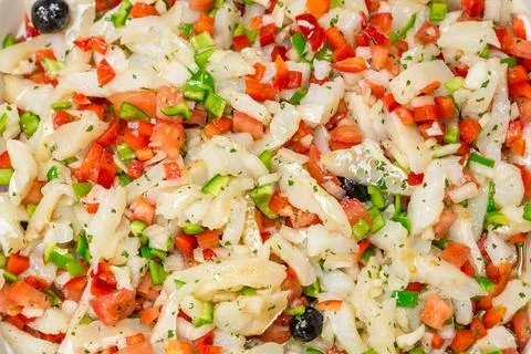 Background cod salad with tomato pepper onion and olives Stock Photos