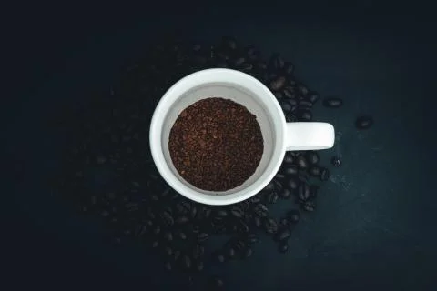 Background From Coffee Grains And A Cup From raw Coffee, The Top View Stock Photos