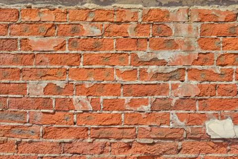 Background of collapsing red brick wall, texture of old cracked brickwork Stock Photos
