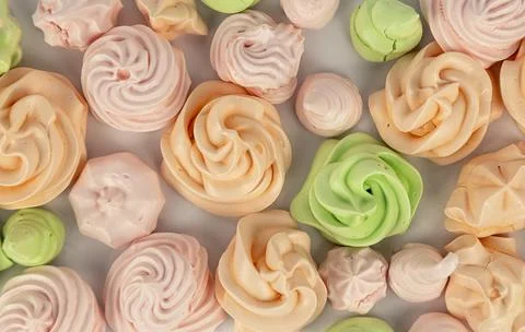 A background of colored meringues laid out next to each other. 스톡 사진