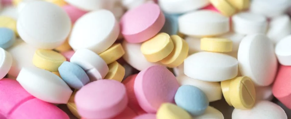 Background colored pink yellow and blue tablets Stock Photos