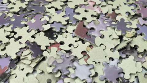 Background with colored puzzle pieces slowly rotating. puzzles in purple tones Video stock 220521875