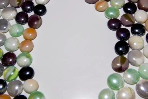 Background of colored round smooth colored stones with a place under the insc Stock Photos