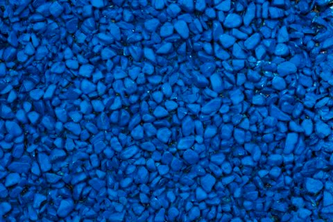 Background of colored small pebbles. The background blue. Stock Photos