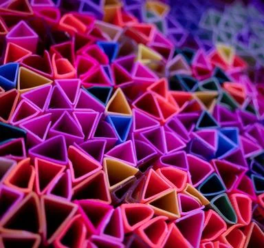 Background of colorful abstract texture with plastic triangles Stock Photos