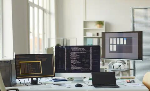 Background of Computers with Code on Screen in IT Office Photos