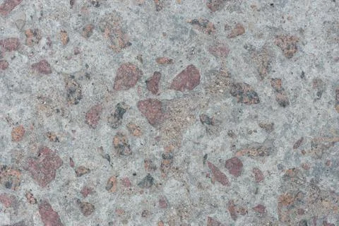Background from concrete with large impregnations of red granite with an uneven Stock Photos