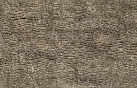 Background of concrete with thin waves scored i Stock Photos