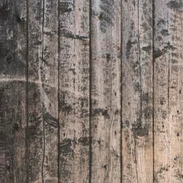 Background consisting of old brown gray grungy part of wooden barn door Stock Photos