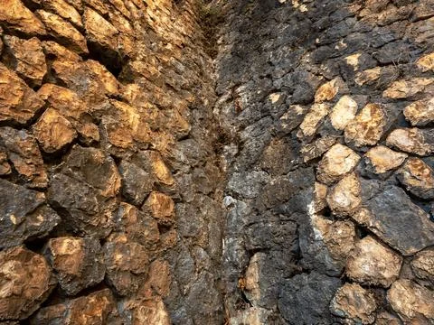 Background consisting of two ancient walls of large stones Stock Photos