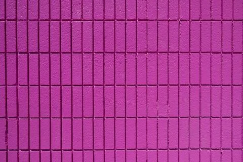Background consisting of a wall of rectangular pink mosaic tiles Stock Photos