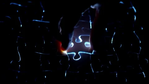The background consists of puzzle elements on dark background. A lot of gold Video stock 336248594