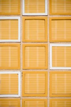 Background created with a close-up of an exterior wall with orange tiles of.. Stock Photos