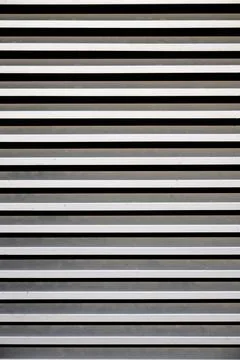 Background created with a close-up of a metal ventilation grille. Stock Photos