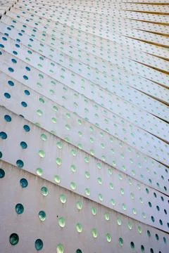 Background created with a concrete structure with holes and green glass. Stockfoto's