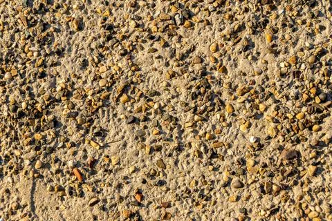 Background created by the surface of sand covered with a heterogeneous layer of Stock Photos