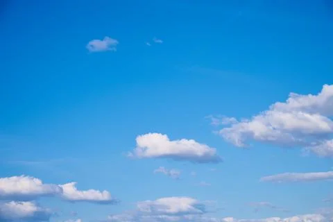 Background created with the texture of a blue sky with white clouds. Stock Photos