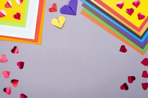 Background for creativity. Colored paper and paper hearts. Cut out of paper Stock Photos