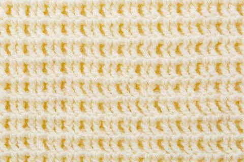 Background of crocheted wool thread of yellow color. Stock Photos