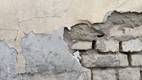 Background of a crumbling brick wall close-up. The texture of a crumbling wall Stock Footage 262861997