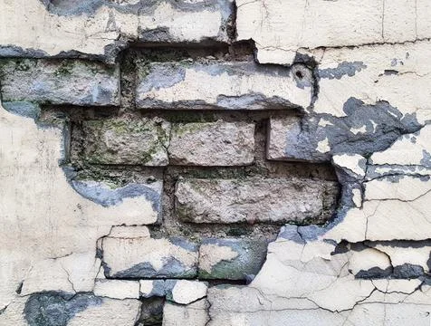 Background of a crumbling brick wall close-up Stock Photos