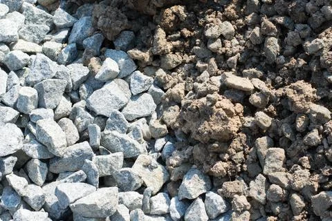 Background of crushed stone and soil against a sun in a pile Stock Photos