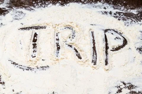 Background culinary idea word trip painted white base flour Stock Photos