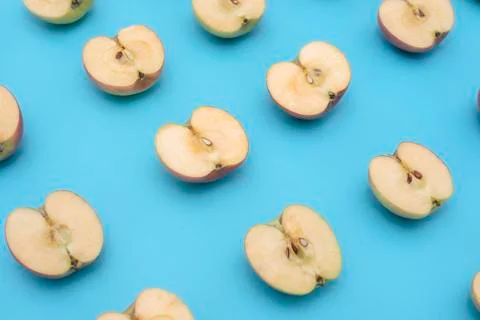 Background of cut in half apples on blue background Stock Photos