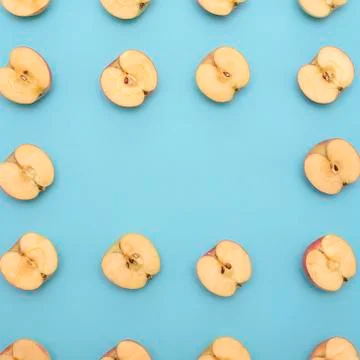 Background of cut in half apples on blue background Stock Photos