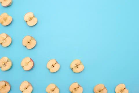 Background of cut in half apples on blue background Stock Photos