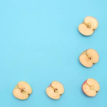 Background of cut in half apples on blue background Stock Photos