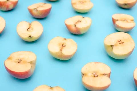 Background of cut in half apples on blue background Stock Photos